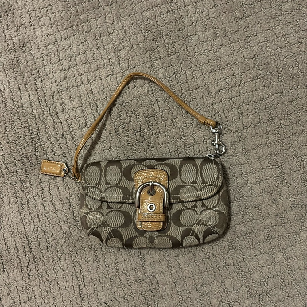 Tiny baby coach purse! It has a magnet to open and close rather than the buckle.